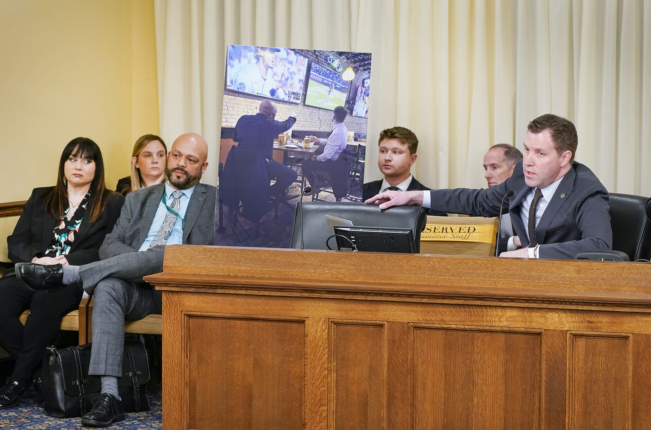 House DFL Floor Leader Jamie Long displays a photo exhibit to the House Ethics Committee during a May 1 probable cause hearing for complaints filed against Rep. Elliott Engen and Rep. Walter Hudson. (Photo by Andrew VonBank)